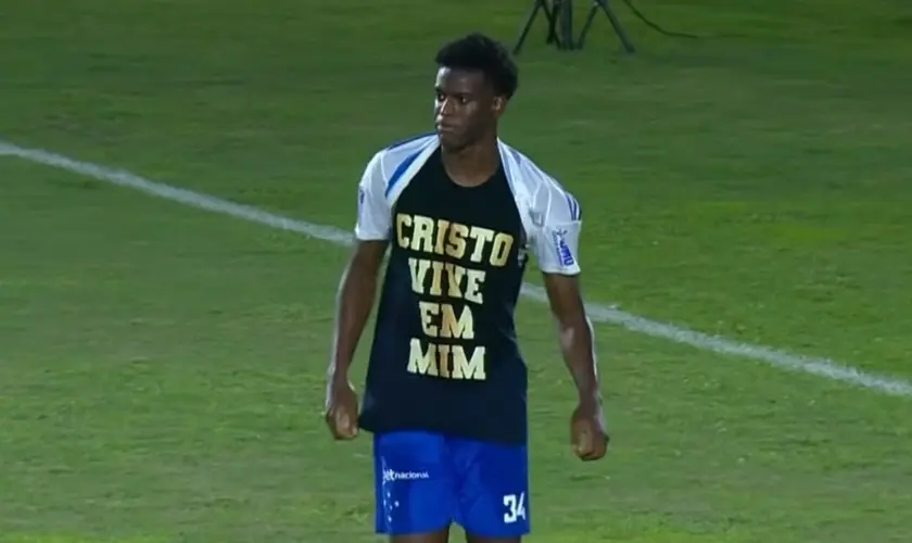 Jogador do Cruzeiro marca gol e chama atenção ao declarar sua fé em campo, exibindo mensagem cristã e versículo bíblico durante a partida. Foto: Reprodução/YouTube/GE TV